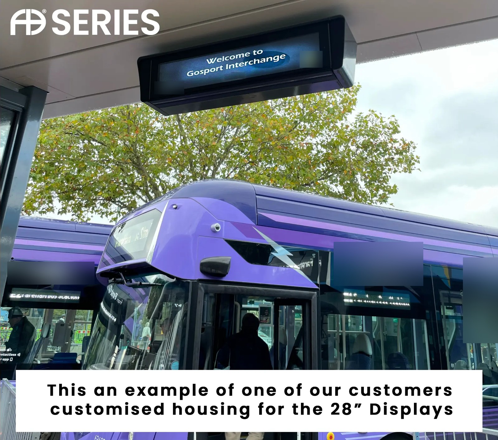 Real customer installation of a 28-inch display in an overhead housing. Customer logos blurred.