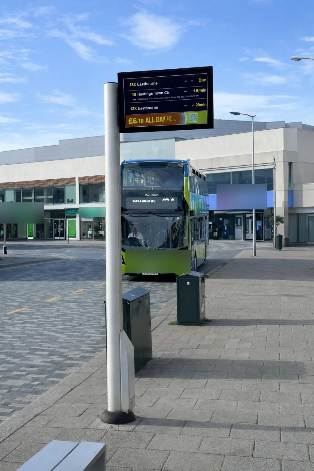 Real pole-mounted passenger information installation. Customer logos blurred.
